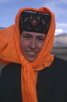 Portrait of a Kazakh woman wearing an orange headscarf