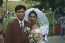 Fashionable western style wedding.  Bride and groom  head and shoulders portrait.