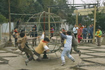 Children playing in park with climbing frames.