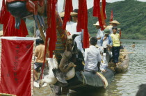 Dragon Boat festival.  View along decorated boat with live geese tied to prow.