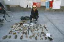 Tibetan medicine man selling parts of plants and animals on the pavement
