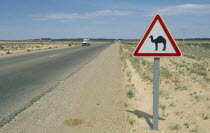 Road sign warning motorists of camels on edge of Sahara desert.