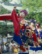Boy in costume with drum and stick at the Tanabata Festival
