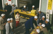 Muslims outside mosque giving donations.