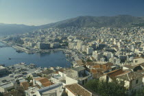 View over town buildings towards distant mountains.