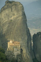 Roussanou Monastery with large rock formation behind.