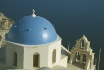 Oia.  Blue domed rooftop of church with sea beyond.Ia Thira Fira Santorini