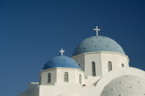 Perissa.  Blue domed rooftops of white painted church.