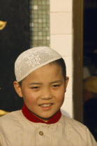 Moslem boy wearing velvet beaded cap