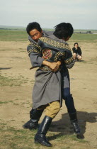 Young men wrestling