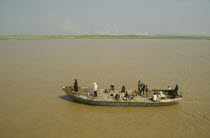 Rusty passenger ferry sailing along the Yellow River