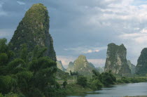 Yangshuo. View through limestone pinnacles standing by the lake.