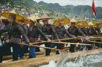 Oarsmen in traditional clothes rowing at dragon boat race