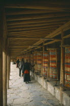 Tibetan pilgrims turning prayer wheels.