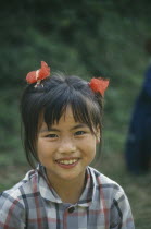 Young girl with ponytails smiling