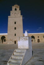 Mosque and courtyard with minaret behind and lecturn in the foreground