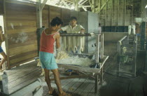 Local rubber factory with men making rubber gloves