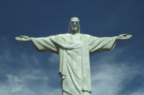 Corcovado Statue of Christ the Redeemer with outstretched arms against backdrop of blue sky