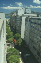Aerial view along city street toward Ipanema and favela  or slum  on a hillside in the distance