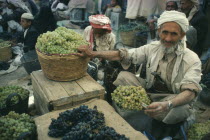 Grape vendor in Souk holding green grapes