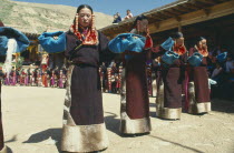 Line of women dancers in costume at Tibetan festival