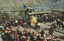 Tibetan festival with people wearing red tassled hats