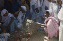 Women sitting around Womans Day drum