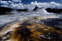 Hot springs with ashen pool of acid dissolved mud and clay in the foreground