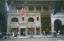 Manhattan s 5th Avenue Christian Dior shopfront with pedestrians walking past