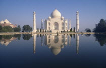 Taj Mahal at sunrise reflected in pool of water
