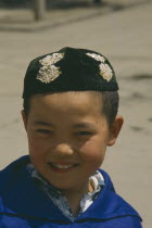 Moslem boy wearing velvet beaded cap