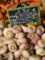 Turnips and carrots on sale at the market in the town of Rouille.
