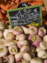 Turnips and carrots on sale at the market in the town of Rouille.