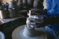 Dedza Potteries producing Fair Trade goods for export.  Cropped view of potter working at wheel.