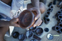 Kadzuwa Crafts.  Cropped view of craftsman producing fair trade carved items for export.