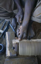 Kadzuwa Crafts.  Cropped view of craftsman using wood turner to produced fair trade carved items for export.