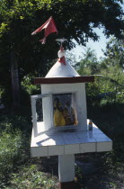 Decorated figures in Hindu shrine.