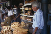 Vendor and customers at bread shop in old market in operation since 1828.