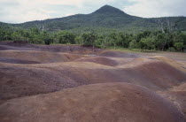 Coloured earth layers created by volcanic rock cooling at different temperatures and as a result of weathering. Colored