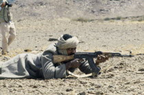 Polisario Front soldier firing kalashnikov.  The Polisario Front is a Sahrawi movement working for the independence of Western Sahara.SADR Sahrawi Arab Democratic Republic Morocco disputed area