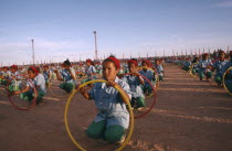 Parade of children with coloured hoops celebrating anniversary of the Polisario Front  the Sahrawi movement working towards independence.SADR Sahrawi Arab Democratic Republic Morocco disputed area Co...