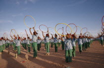 Parade of children with coloured hoops celebrating anniversary of the Polisario Front  the Sahrawi movement working towards independence.SADR Sahrawi Arab Democratic Republic Morocco disputed area Co...