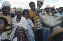 Merina bone turning ceremony or famadihana in which the remains of a relative are exhumed celebrated and danced with before being wrapped in clean shroud and reburied.