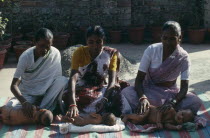 Women massaging their babies.Alternative medicine Kolkata
