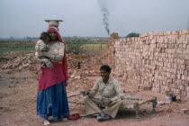 Construction worker couple and their baby.