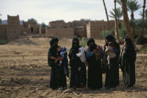 Women and babies from settlement in oasis near Zagora.