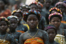 Young girls in traditional dress and body paint at ancestor worship ceremony.