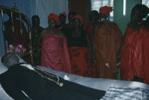 Funeral of man from the Ga community.  His wife talks to her dead husband as is customary during the wake.
