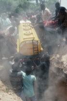 Burial of driver Peter Borkety Kuwono in oil tanker shaped coffin.