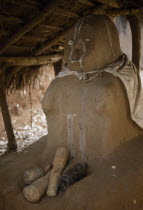 Fetish figure at shrine entrance in black magic temple.